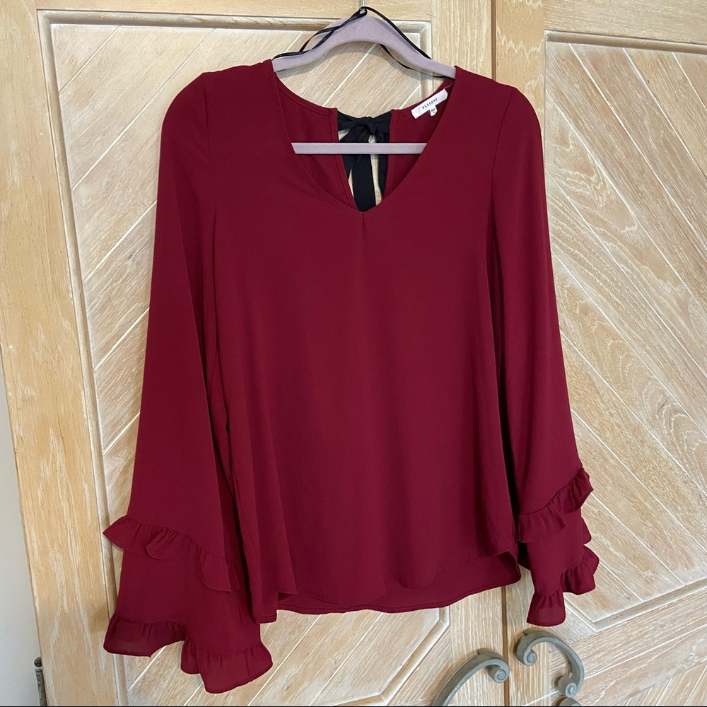 Pleione garnet top with black grosgrain ribbon tie in back.
